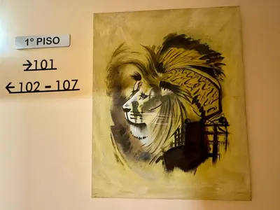 a painting of a woman with feathers on a wall at Hotel Reigosa in Pontevedra