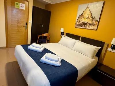 a bedroom with a large bed with towels on it at Hotel Reigosa in Pontevedra