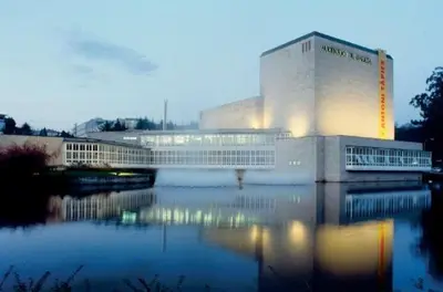 a building with a reflection in a body of water at NC APARTMENT in Santiago de Compostela