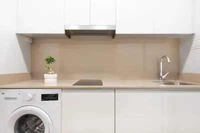 a kitchen with a washing machine and a sink at NC APARTMENT in Santiago de Compostela
