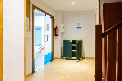 a hallway with a green cabinet and a door at Hotel Alda Fogar do Mariñeiro in Ribadeo