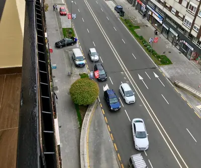 an aerial view of a city street with cars parked at Soleado a un Paseo de la Catedral in Santiago de Compostela