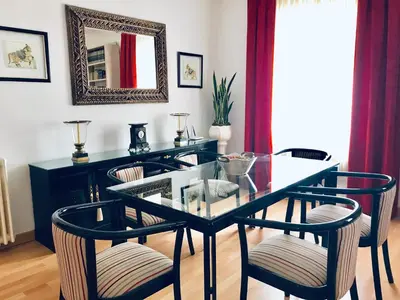 a dining room with a glass table and chairs at Casa de la Playa in Vega de Espinareda