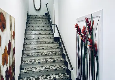 a staircase in a house with a painting at Casa de la Playa in Vega de Espinareda