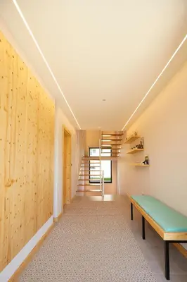 a hallway with a bench and stairs in a house at Apartamentos Arumes do Mar e Montaña - Viveiro in Viveiro