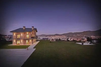 a large house sitting on top of a lush green field at Apartamentos Arumes do Mar e Montaña - Viveiro in Viveiro