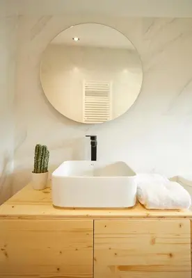a bathroom with a white sink and a mirror at Apartamentos Arumes do Mar e Montaña - Viveiro in Viveiro