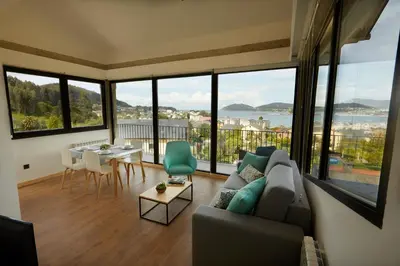 a living room with a couch and a table at Apartamentos Arumes do Mar e Montaña - Viveiro in Viveiro