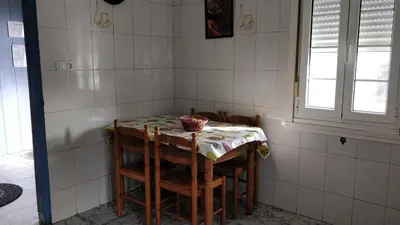 a table in a kitchen with a table and chairs at Casa do Gaiteiro - Casa de Aldea en O Pereiro in Pereiro