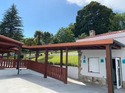 a patio with a deck and a building at Albergue Mirador de Pedrouzo in O Pedrouzo