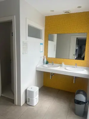 a bathroom with two sinks and a mirror at Albergue Mirador de Pedrouzo in O Pedrouzo