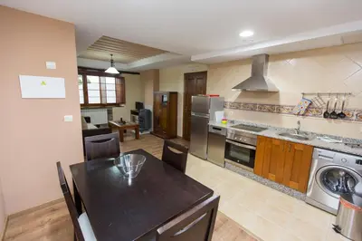 a large kitchen with a table and a dining room at Apartamentos Casa Mateo in Navia