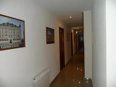 a hallway of a building with a picture on the wall at Hostal Coruña in Astorga