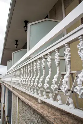 a balcony with white railings on a building at HOTEL LORENZO in Carballino