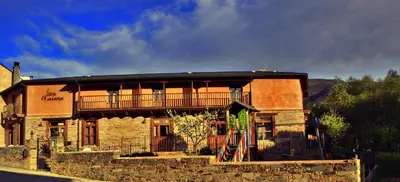 a building with a balcony on top of it at Las Fontaninas in Noceda del Bierzo