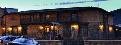 a building with cars parked in front of it at Las Fontaninas in Noceda del Bierzo