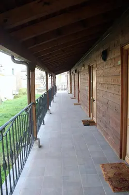 an empty porch of a wooden building with a railing at Las Fontaninas in Noceda del Bierzo