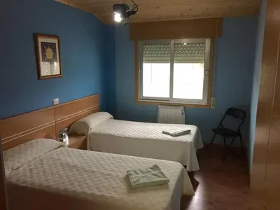a room with two beds and a window at M Ramona Reja Díaz in Lourenzá