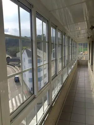 an empty hallway with windows in a building at M Ramona Reja Díaz in Lourenzá
