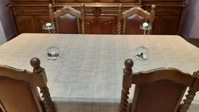 a dining room table with a table cloth and two chairs at Casa Rosalía in Silleda