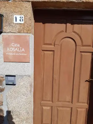 a door to a building with a sign on it at Casa Rosalía in Silleda