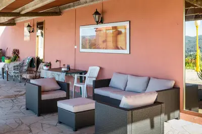 a patio with couches and a table and chairs at Casa Rosalía in Silleda