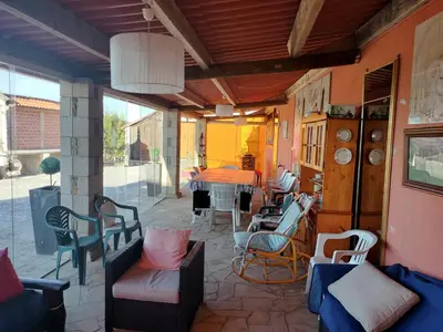 a patio with chairs and a table on a patio at Casa Rosalía in Silleda