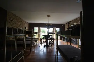 a room with several bunk beds and a table at CASA PELTRE in Sarria