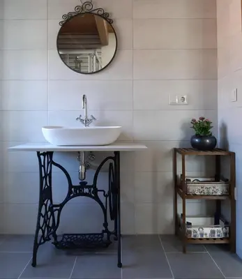 a bathroom with a sink and a mirror at Casa Perdigueira in Castromayor