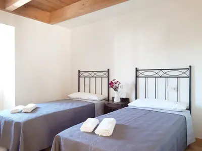 two beds with towels on them in a room at Casa Perdigueira in Castromayor