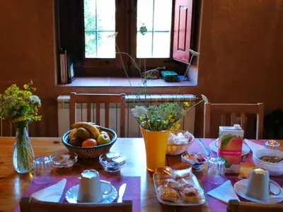 a wooden table with a bowl of fruit on it at Casa Rural Las Águedas in Murias de Rechivaldo