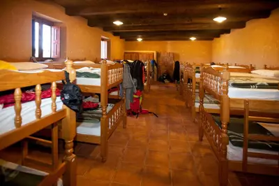 a room filled with lots of bunk beds at Albergue Rural Las Águedas in Murias de Rechivaldo
