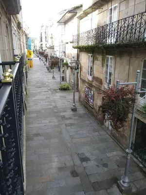 an empty street in an alley between two buildings at Apartamento La Real in Caldas de Reis