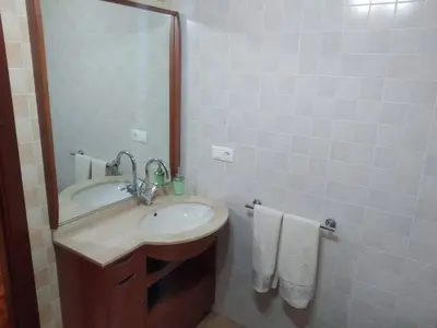 a bathroom with a sink and a mirror at Apartamento La Real in Caldas de Reis