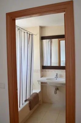 a bathroom with a sink and a mirror at Chalet adosado en Costa Miño a un paso de la playa in Miño
