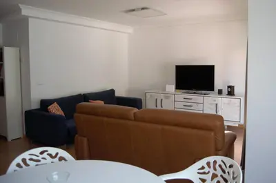 a living room with a couch and a tv at Chalet adosado en Costa Miño a un paso de la playa in Miño