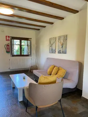 a living room with a couch and a table at El Mirador de Sanabria in Galende