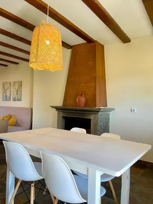 a dining room with a white table and chairs at El Mirador de Sanabria in Galende
