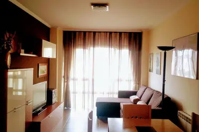 a living room with a couch and a large window at Foz vacaciones a orillas del mar in Foz