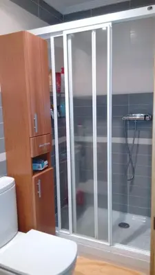 a bathroom with a glass shower with a toilet at Foz vacaciones a orillas del mar in Foz