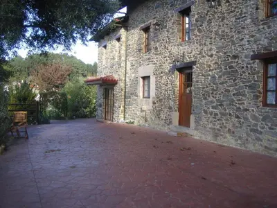 a stone building with a door and a walk way at Casa de Sixto in Paderne