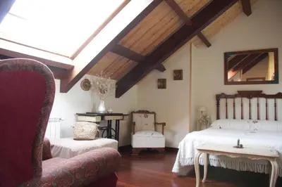 a attic bedroom with two beds and a skylight at Casa de Sixto in Paderne