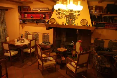 a dining room with a table and a fireplace at Casa de Sixto in Paderne