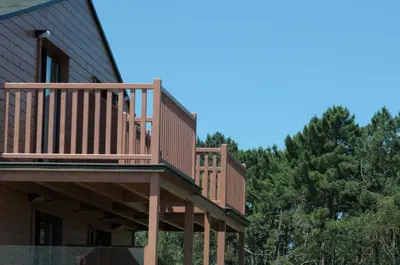 a deck on the side of a house at Cabanas Da Barcela in Barreiros