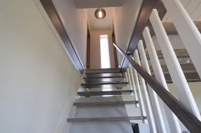 a staircase in a house with wooden railings at Cabanas Da Barcela in Barreiros
