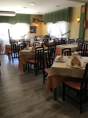 a dining room with tables and chairs in a restaurant at Hotel Garcas in Lavacolla