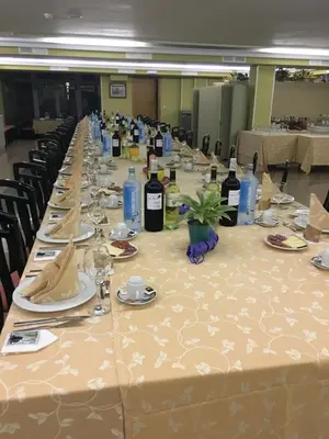 a long table with bottles of wine on it at Hotel Garcas in Lavacolla