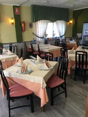 a dining room with tables and chairs in a restaurant at Hotel Garcas in Lavacolla