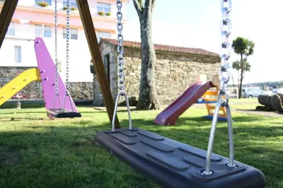 a group of swings in a park at Hotel Garcas in Lavacolla