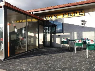 a store front with chairs and a sign that reads dont pee at HOSTAL RESTAURANTE DON PEPE in Ourense